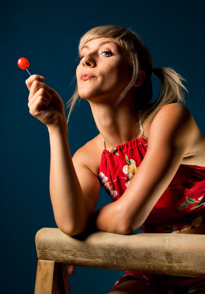 Cute blonde posing with a lollipop - Foto, immagini