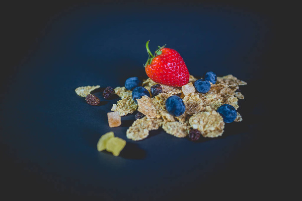 whole grain cereal flakes which mixed berry fruit and raisins - Photo, Image
