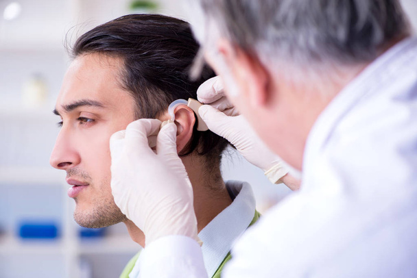 Male patient with hearing problem visiting doctor otorhinolaryng - Фото, зображення