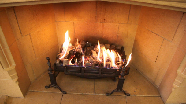 Close-up shot of flame in fireplace of brown room - Footage, Video
