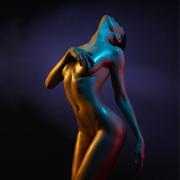 Elegant nude model in the light colored spotlights - Foto, Imagem