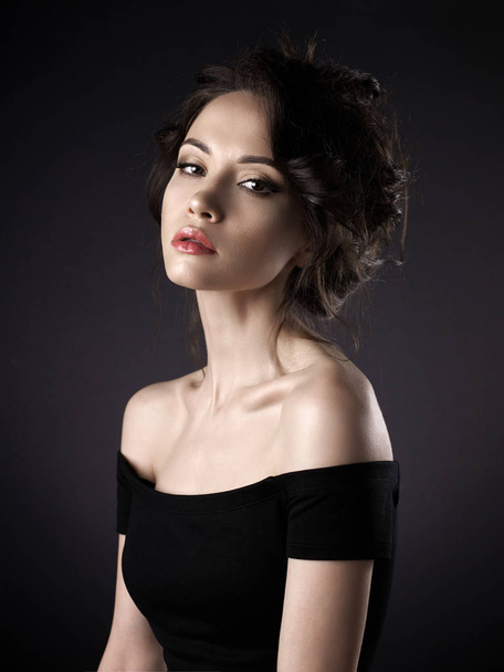 Beautiful woman with elegant hairstyle on black background - Foto, imagen