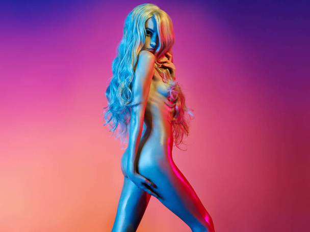 Nude sexy blonde in colorful light. Night club dance - Fotó, kép