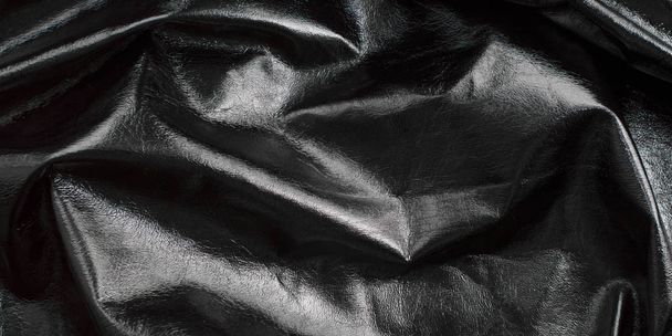 background of black textured, glossy leather, rumpled, shiny fabric - Photo, Image