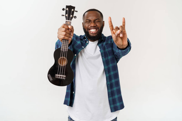 Young handsome african american man plays ukulele isolate over white background, - Foto, Bild