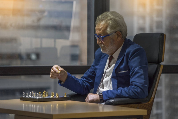 Διευθύνων Σύμβουλος που παίζει σκάκι, σκέφτεται τον επιχειρηματικό προγραμματισμό της εταιρικής στρατηγικής - Φωτογραφία, εικόνα