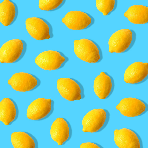 Summer fruit pattern of lemons on a bright blue background - Foto, Bild