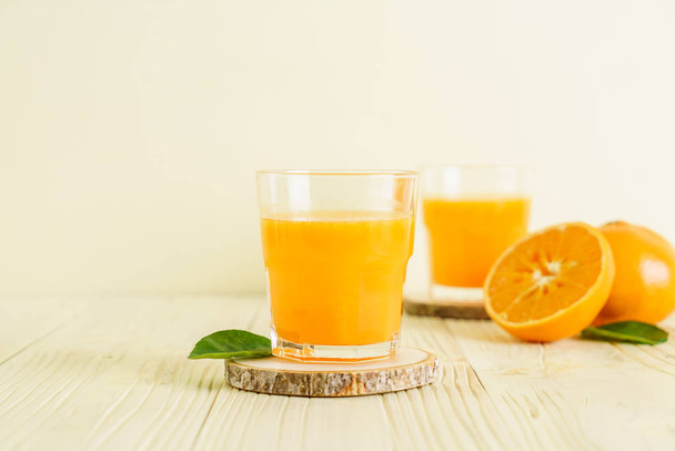 Fresh orange juice on wood background - Zdjęcie, obraz