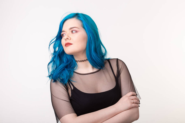 People and fashion concept - Beautiful woman with blue hair posing over white background - Foto, Bild