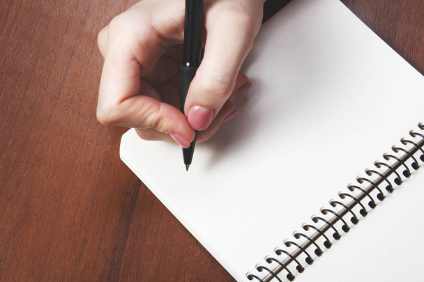 woman writing with black pen on notebook - Foto, Bild