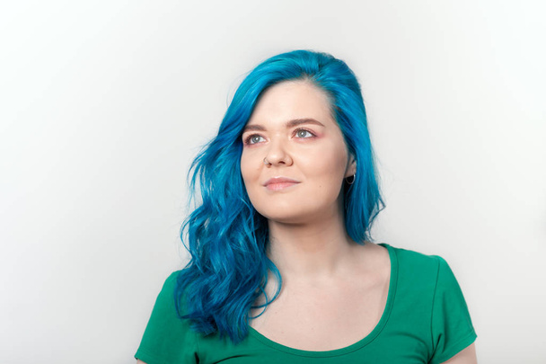 Youth, stylish and fashion concept - Young beautiful woman with blue hair is smiling over white background - Photo, Image