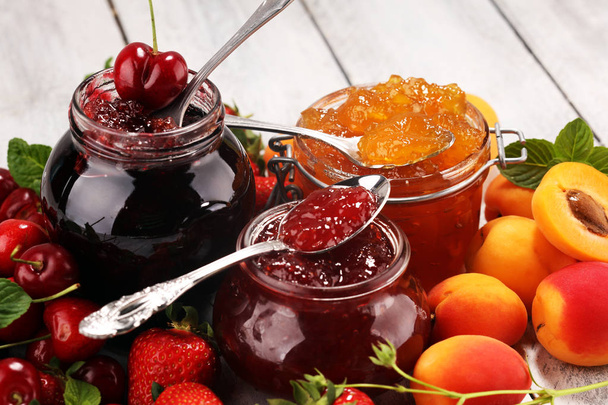 assortment of jams, seasonal berries, apricot, mint and fruits.  - Photo, Image