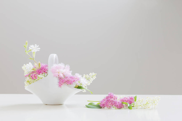 cup of tea and flowers on table at home - Фото, изображение