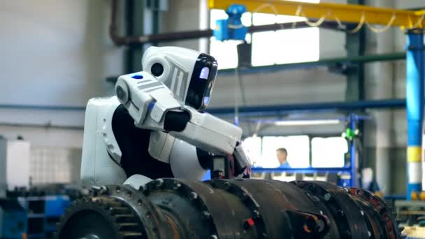Industrial mechanism is being drilled by a cyborg - Footage, Video