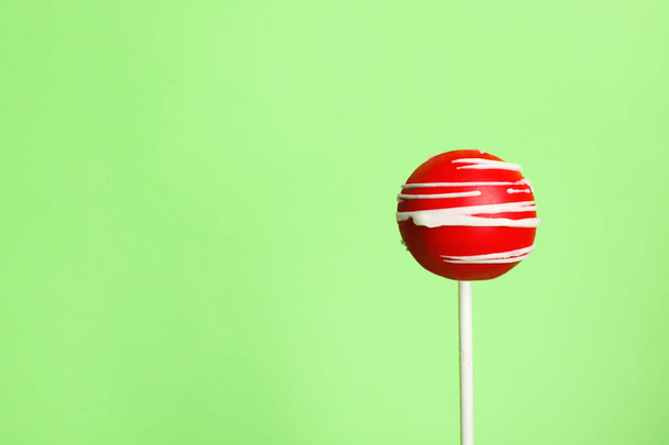 Bright delicious cake pop on color background. Space for text - Foto, imagen