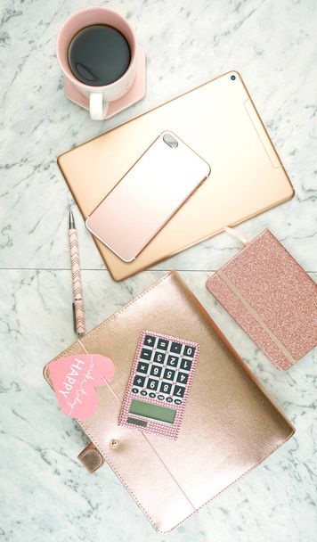 Feminine desk workspace with rose gold accessories flatlay. - Photo, Image