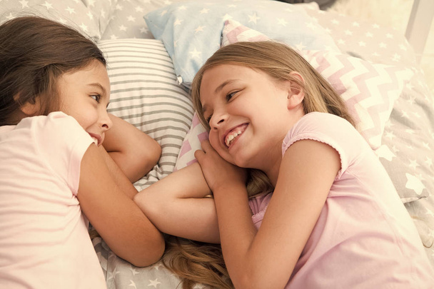 Best friends forever. Girls relaxing on bed. Slumber party concept. Girls just want to have fun. Invite friend for sleepover. Consider theme slumber party. Slumber party timeless childhood tradition - Valokuva, kuva
