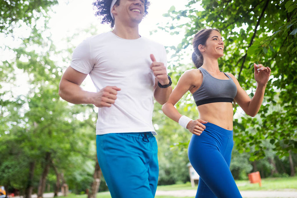 Couple jogging and running outdoors in nature - Φωτογραφία, εικόνα