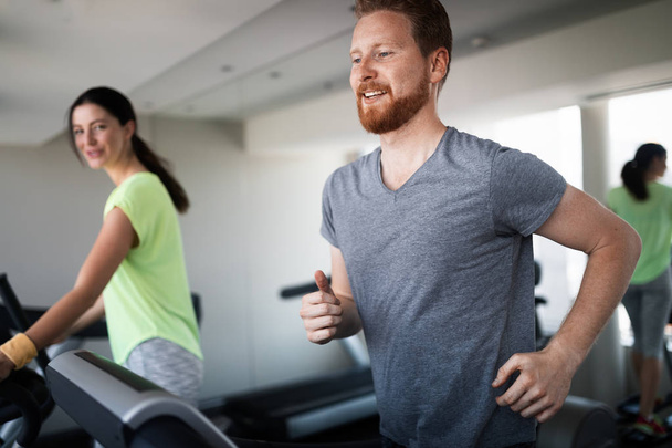 People running on a treadmill in health club cardio - Fotó, kép