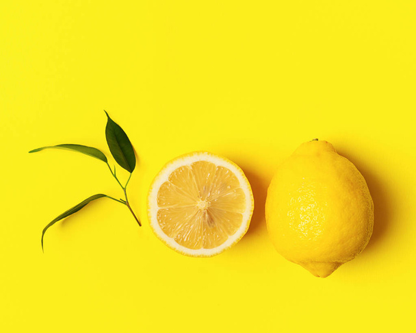 Fresh juicy lemon on a bright yellow background. Concept minimalism. Horizontal frame. Copy space. - Photo, image