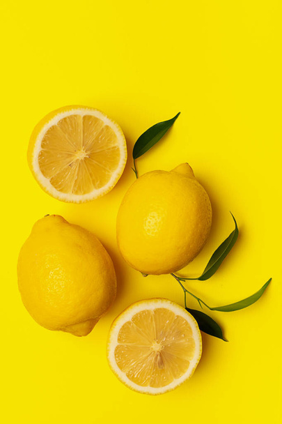 Fresh juicy lemon on a bright yellow background. Concept minimalism. Horizontal frame. Copy space. - 写真・画像