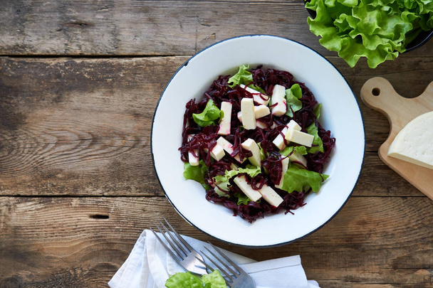 Beet salad with cheese and lettuce in a white bowl                                - Photo, Image