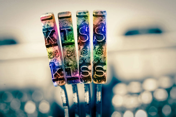 Het woord Kiss met oude typemachine in de regenboog - Foto, afbeelding