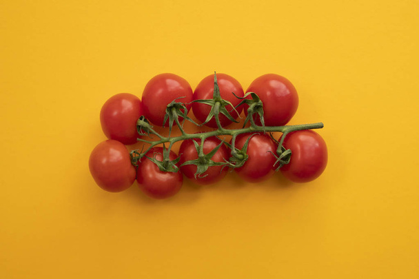 Close up ripe tomato on bright yellow background top view flat l - Foto, Imagen