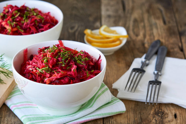 Vegetable salad with beets, cabbage and carrots in a white bowl                                - Photo, Image