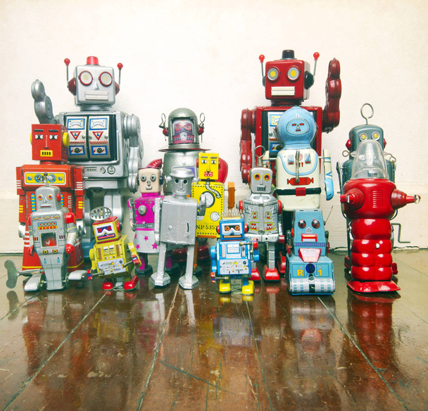 un gran grupo de juguetes robot de estaño retro en un piso de madera viejo
   - Foto, Imagen