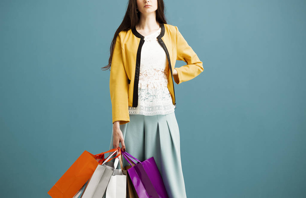 Stylish woman carrying a lot of shopping bags - 写真・画像