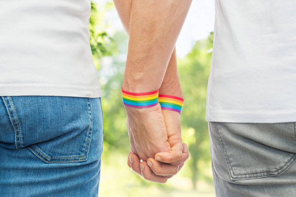 male couple with gay pride rainbow wristbands - Photo, Image
