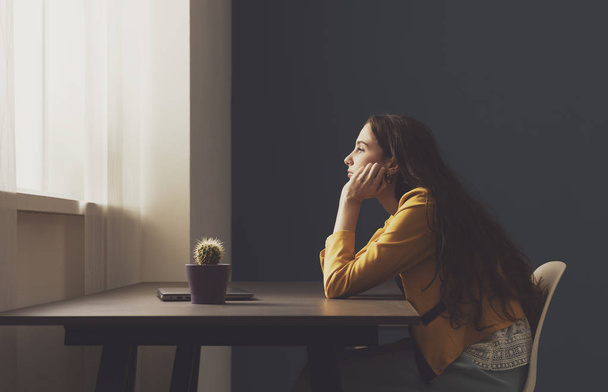 Sad lonely young woman sitting at home - Valokuva, kuva