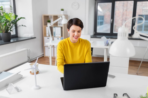 happy businesswoman with laptop working at office - Photo, Image
