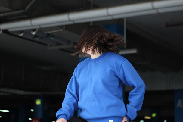 Girl  in blue hoodie. Street style. Advertising brand clothing.  - Photo, Image