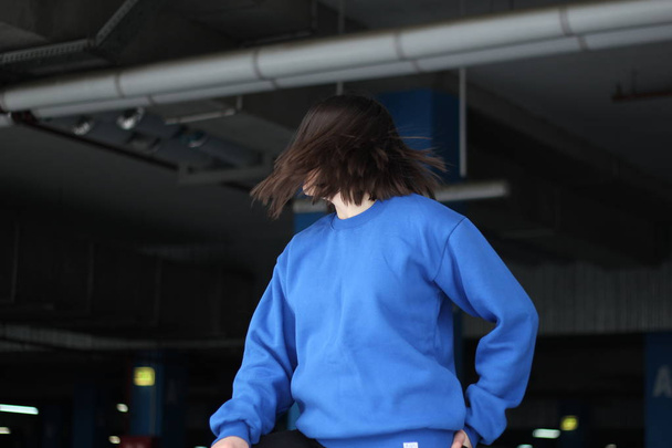Girl  in blue hoodie. Street style. Advertising brand clothing.  - Photo, Image