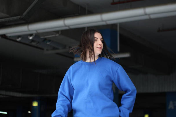 Girl  in blue hoodie. Street style. Advertising brand clothing.  - Foto, imagen
