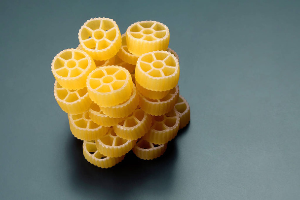 uncooked dry pasta in the shape of a whee - Photo, Image