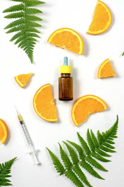 Citrus fruit essential oil, vitamin c serum, beauty care aroma therapy. High dose vitamin c synthetic for skin. Flat lay, top view, copy space - Foto, Imagen