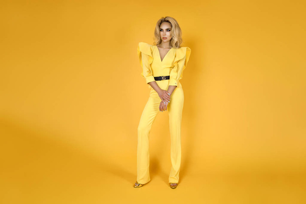 Fashionable woman in nice yellow jumpsuit, shoes and accessories. Fashion spring summer photo - Image - Fotó, kép