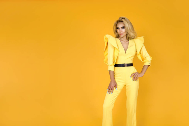 Fashionable woman in nice yellow jumpsuit, shoes and accessories. Fashion spring summer photo - Image - Fotografie, Obrázek