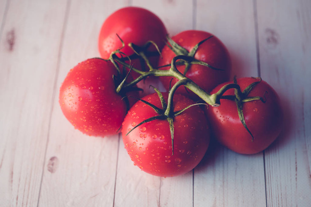 Tomates maduros con gotas de agua en la mesa
 - Foto, Imagen