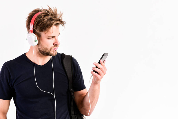 Enjoy sound headphones. Music gadget. Musical accessory gadgets. Man listen music online headphones and smartphone. Modern technology. Radio wave. Pop music. Mp3 player concept. Music application - Zdjęcie, obraz