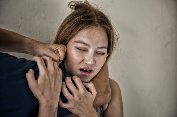 Мужчина использует руку, чтобы задушить шею женщины
 - Фото, изображение