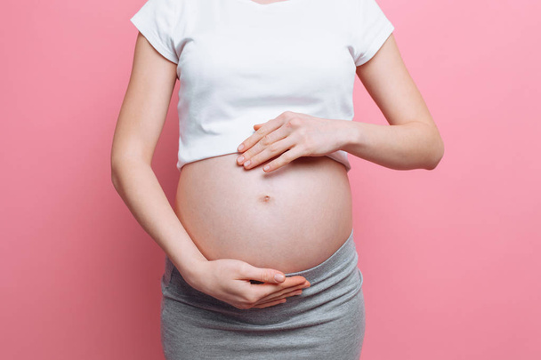 Pregnant woman holding belly with love, third trimester - Φωτογραφία, εικόνα