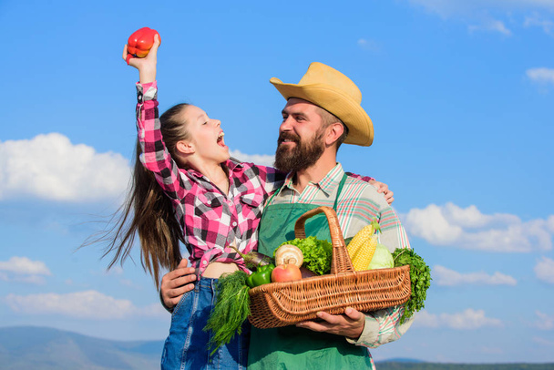 Farmer family homegrown harvest. Only organic and fresh harvest. Father and daughter hold basket harvest vegetables. Gardening and harvesting. Family farm concept. Man bearded rustic farmer with kid - Fotografie, Obrázek