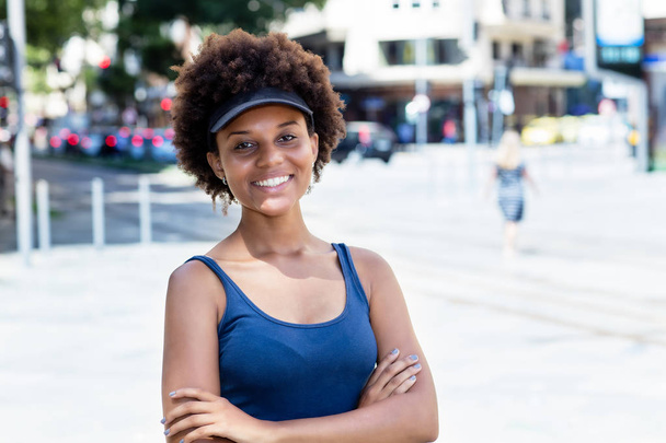 Laughing african american young adult woman in city - Φωτογραφία, εικόνα