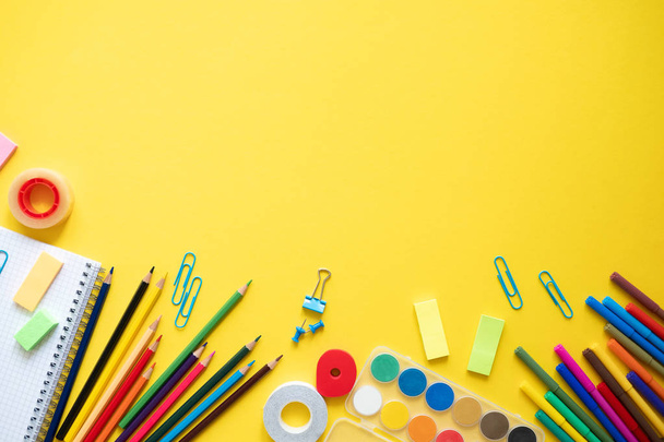 School supplies on yellow background. Concept back to school. Copy space - 写真・画像
