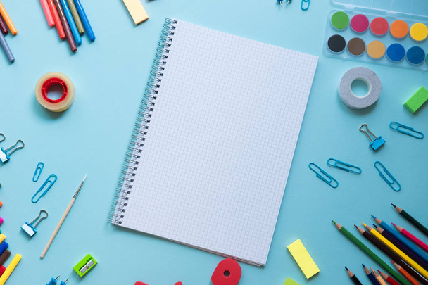School supplies lay on blue background, back to school concept, copy space - Foto, Imagen