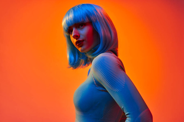 Young futuristic woman under neon light - Valokuva, kuva